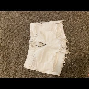 White ripped shorts